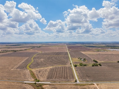 Overview of rural landscape featuring rows of crops