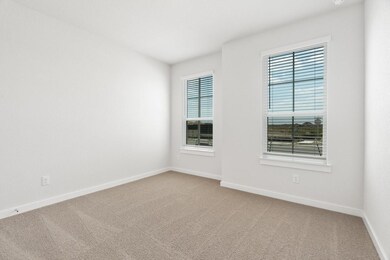 Unfurnished room with light carpet and baseboards