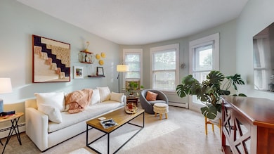 Wonderful living room filled with eastern light. It also provides private balcony access.