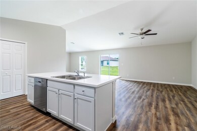 Kitchen featuring stainless steel dishwasher, dark