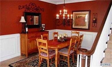 Dining room with wainscoting, crown molding.