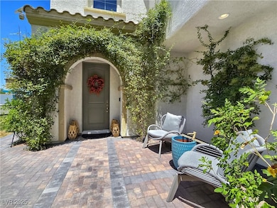 Property entrance with stucco siding and a patio a