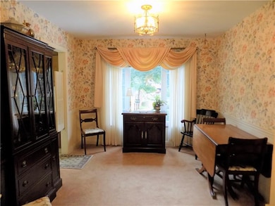 Dining room features chair rails and Wainscoting. 