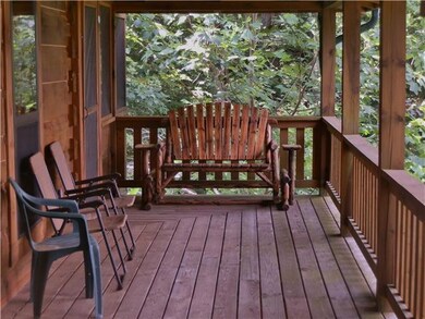 Wrap around porch with a metal roof.