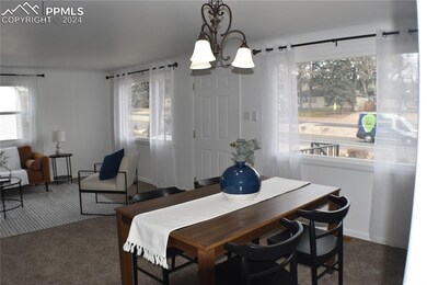 Dining space featuring a notable chandelier, dark 
