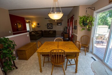 Dinette area with patio doors leading to deck.