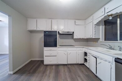 Kitchen featuring black appliances, sink, white ca