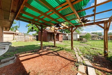 Charming backyard featuring a covered patio with a