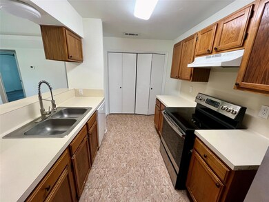 Kitchen featuring under cabinet range hood, stain