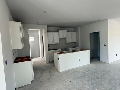 Kitchen featuring a kitchen island, unfinished con