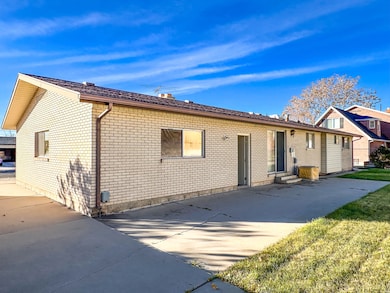 Back of house with brick siding and entry steps
