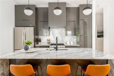 Kitchen featuring gray cabinets, modern cabinets, 