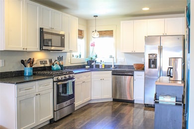 Kitchen featuring stainless steel appliances & white cabinets