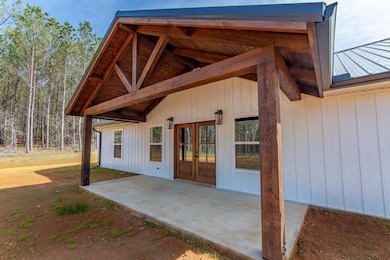 Doorway to property featuring a patio and french d