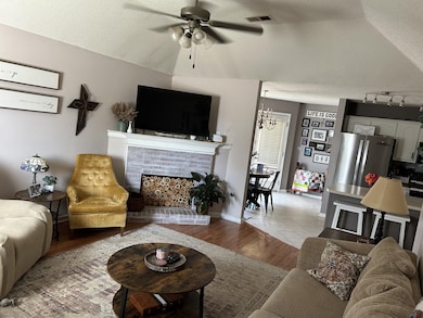 Tiled living room with ceiling fan with notable ch