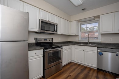 Kitchen featuring stainless steel appliances, dark