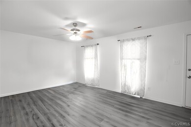 Empty room with ceiling fan and hardwood / wood-st