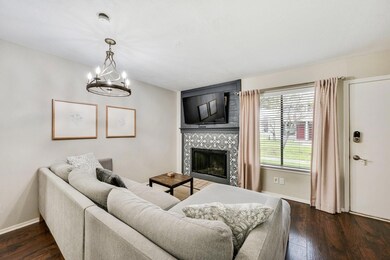 Living room with an inviting chandelier, a tile fi