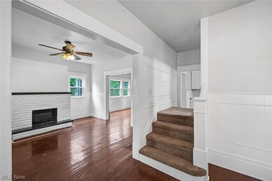 Stairway with dark wood-type flooring and ceiling fan