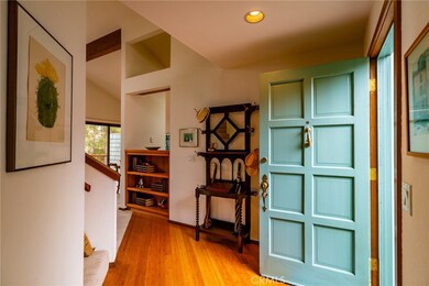 Left to bedrooms, stairs to loft, straight ahead to living, dining, kitchen and deck.