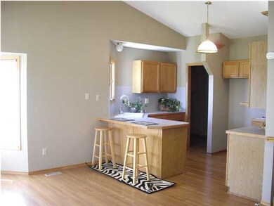 Laminate wood floor inb kitchen, laundry, great rm