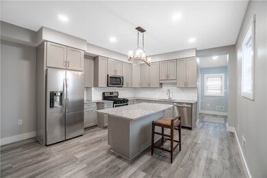 Kitchen, side entrance and full bath in the back.