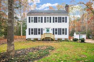 Colonial-style house featuring a shed and a front