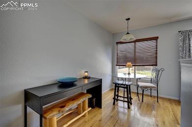 Dining room featuring light wood-style flooring and baseboards