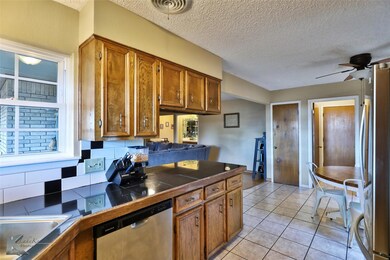 Kitchen with backsplash, stainless steel appliance