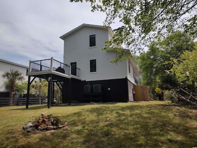 Rear view of house featuring fence, a wooden deck,