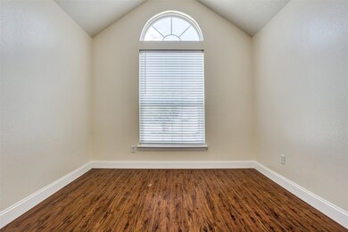 Empty room with baseboards and dark wood-style flooring