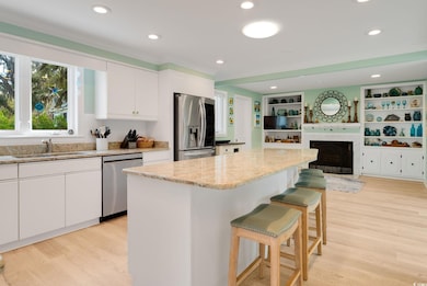 Kitchen featuring a sink, light wood finished floo