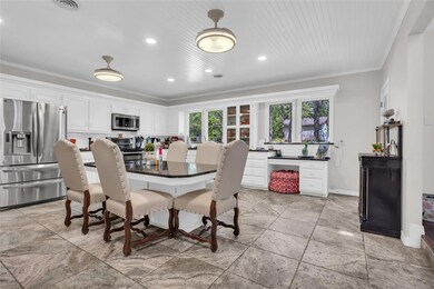 Dining room with stone tile floors, baseboards, re