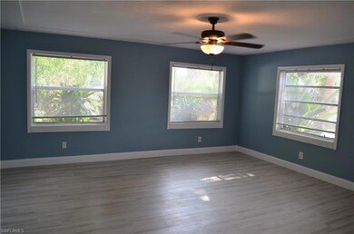 Spare room featuring ceiling fan and hardwood / wo