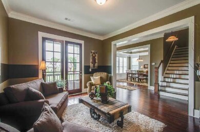 Formal living room features glass french doors out