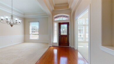 The front door opens to a light-filled grand center hall that leads to the rear of the home. The dining room is on the left and the study/living room on the right.