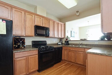 Kitchen has 42 inch cabinets, a breakfast bar and 