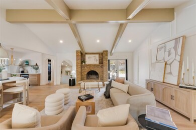 Living area with vaulted ceiling with beams, light