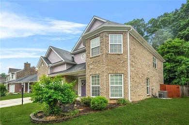 View of front of home featuring brick siding, cent