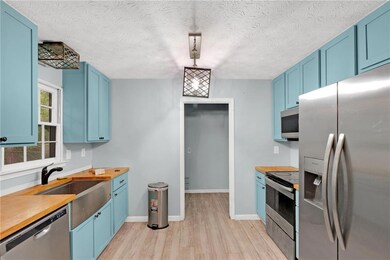 Kitchen featuring light wood-style floors, stainle
