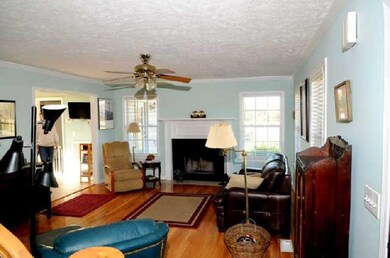 Enjoy the warmth of a fireplace on these chilly nights in this large living room.