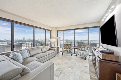 The spacious living room features walls of windows