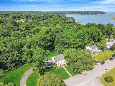 Bird's eye view of a nearby body of water and a heavily wooded area