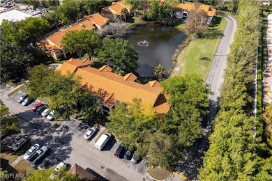 Birds eye view of property with a water view