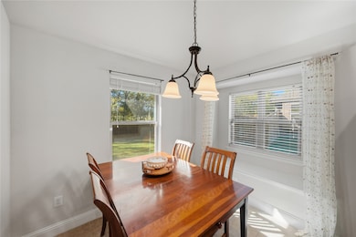 Breakfast area with healthy amount of natural light and light tile patterned flooring