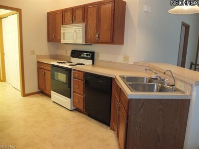 Fully applianced kitchen with breakfast bar.