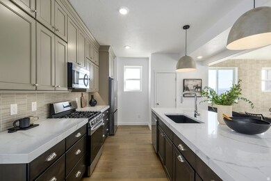 A total 'wow' kitchen-quartz countertops, stainless appliances, and a big island for charcuterie or homework.*Model Home