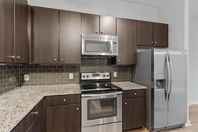 Kitchen with stainless steel appliances and dark 