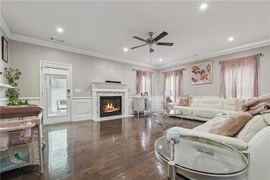 Living area with ornamental molding, a fireplace, 