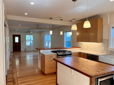 Kitchen with tasteful backsplash, open floor plan